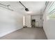 Garage featuring a water heater, painted concrete floor, and overhead door with window at 306 Chestnut St, Oldsmar, FL 34677