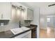 Updated kitchen featuring gray tile backsplash and ample counter space at 306 Chestnut St, Oldsmar, FL 34677