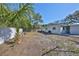 The backyard features a small palm tree and a white fence at 3218 N 16Th St, Tampa, FL 33605