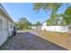 Expansive backyard featuring a white fence, mature trees, and ample space for outdoor activities and relaxation at 3218 N 16Th St, Tampa, FL 33605