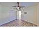 Inviting bedroom with wood-look floors, a ceiling fan, and a closet with bi-fold doors at 3218 N 16Th St, Tampa, FL 33605