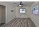 Cozy bedroom featuring wood-look floors, a ceiling fan, and natural light from a window at 3218 N 16Th St, Tampa, FL 33605