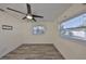 Bright bedroom with ceiling fan, wood-look floors, and a window providing natural light at 3218 N 16Th St, Tampa, FL 33605
