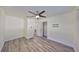 Spacious bedroom featuring wood-look floors, a ceiling fan, and access to a closet at 3218 N 16Th St, Tampa, FL 33605