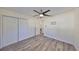 This bedroom features a ceiling fan, light gray vinyl plank flooring, and a double closet at 3218 N 16Th St, Tampa, FL 33605