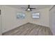 This bedroom features light gray vinyl plank flooring, two windows, and a closet at 3218 N 16Th St, Tampa, FL 33605