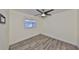 This bedroom features light gray vinyl plank flooring, a window, and a ceiling fan at 3218 N 16Th St, Tampa, FL 33605