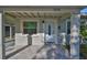 Close-up of the home's front entrance featuring a tiled patio, storm door, and painted stucco facade at 3218 N 16Th St, Tampa, FL 33605