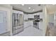 Stylish kitchen featuring stainless steel appliances, granite counters and sleek white cabinets at 3218 N 16Th St, Tampa, FL 33605