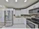 Bright kitchen with stainless steel appliances, white cabinets, and elegant backsplash at 3218 N 16Th St, Tampa, FL 33605