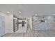 Open-concept layout featuring a modern kitchen and a living area with a decorative stone wall at 3218 N 16Th St, Tampa, FL 33605
