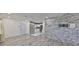 Large living room leads to the kitchen, complete with stainless appliances and white cabinets at 3218 N 16Th St, Tampa, FL 33605
