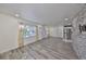 Open-concept living room with light wood floors, stone accent wall, and lots of natural light at 3218 N 16Th St, Tampa, FL 33605