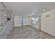 Spacious living room featuring light wood floors, white walls, stone accent wall with mounted TV at 3218 N 16Th St, Tampa, FL 33605