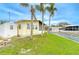 Canal-front home with a storage shed, firepit, and tropical landscaping by the water at 35246 Tiffani Ct, Zephyrhills, FL 33541