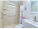 Compact bathroom with a shower, grab bar, shelves, and a sink with cabinet at 35246 Tiffani Ct, Zephyrhills, FL 33541