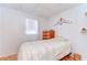 Simple bedroom featuring a comfortable bed and wooden dresser at 35246 Tiffani Ct, Zephyrhills, FL 33541