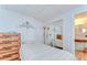 Bright bedroom featuring a comfortable bed, mirrored closet doors and dresser at 35246 Tiffani Ct, Zephyrhills, FL 33541