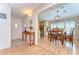 Inviting dining area with hardwood floors, traditional table set, and view into the front entry at 35246 Tiffani Ct, Zephyrhills, FL 33541