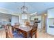 Comfortable dining area with wooden table set for six with connecting access to other rooms at 35246 Tiffani Ct, Zephyrhills, FL 33541