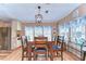 An inviting dining area with a wooden table set for six next to the kitchen at 35246 Tiffani Ct, Zephyrhills, FL 33541