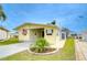 Delightful yellow home with tidy lawn, mature landscaping, and convenient proximity to sidewalks at 35246 Tiffani Ct, Zephyrhills, FL 33541