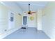 Covered porch with painted floor and a decorative sun hanging next to the front door at 35246 Tiffani Ct, Zephyrhills, FL 33541
