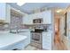 Well-equipped kitchen with white cabinetry, stainless steel appliances, and tile backsplash detail at 35246 Tiffani Ct, Zephyrhills, FL 33541
