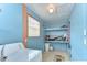 Functional laundry room with ample storage shelves, washer, and window, ready for use at 35246 Tiffani Ct, Zephyrhills, FL 33541