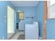 Bright laundry room with a washer and dryer unit visible through an adjoining room at 35246 Tiffani Ct, Zephyrhills, FL 33541