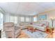 Inviting living room featuring a large sectional sofa and comfortable armchair at 35246 Tiffani Ct, Zephyrhills, FL 33541