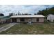 Charming single-story home with metal roof, brick accents, and tidy front yard landscaping at 3751 Cullen St, New Port Richey, FL 34652