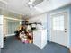 Utility room featuring white appliances, storage shelves, and ceiling fan at 3751 Cullen St, New Port Richey, FL 34652