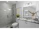 Bright bathroom featuring a glass shower with gray tile and a granite-topped vanity at 3801 Bayshore Blvd, Tampa, FL 33611