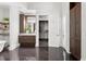 Modern bathroom with dark marble floors, wooden cabinets, double vanity, and walk-in closet at 3801 Bayshore Blvd, Tampa, FL 33611