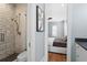 View of a bathroom with marble shower and the bedroom is visible through the doorway at 3801 Bayshore Blvd, Tampa, FL 33611