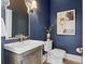 Chic powder room featuring a textured wall, unique mirror, and decorative lighting at 3801 Bayshore Blvd, Tampa, FL 33611