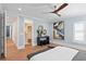 Light filled bedroom features a modern ceiling fan, stylish decor, and a view into the walk-in closet at 3801 Bayshore Blvd, Tampa, FL 33611