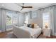 Comfortable bedroom featuring hardwood floors, a ceiling fan, bright white walls, and large windows at 3801 Bayshore Blvd, Tampa, FL 33611