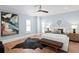 Comfortable bedroom featuring hardwood floors, a ceiling fan, light blue walls, and stylish decor at 3801 Bayshore Blvd, Tampa, FL 33611