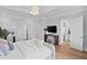 Bright bedroom featuring neutral decor, a large bed, bedside tables, and wood floors at 3801 Bayshore Blvd, Tampa, FL 33611