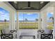 Elegant covered patio featuring comfortable seating, a ceiling fan, and stunning water views at 3801 Bayshore Blvd, Tampa, FL 33611