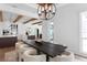 Dining area with wood beam ceilings and modern chandelier looking into the kitchen at 3801 Bayshore Blvd, Tampa, FL 33611