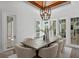 Dining room with tray ceiling, unique light fixture and views of the yard at 3801 Bayshore Blvd, Tampa, FL 33611