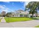 A sprawling two-story home with manicured front lawn, a covered porch, and street view at 3801 Bayshore Blvd, Tampa, FL 33611