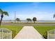 Exterior view from the porch featuring brick pathway with water view and landscaping at 3801 Bayshore Blvd, Tampa, FL 33611