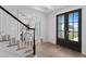 Bright foyer featuring wood floors, staircase, and view of dining room at 3801 Bayshore Blvd, Tampa, FL 33611