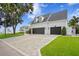 Spacious garage with three bays and a brick paved driveway, surrounded by well-maintained landscaping at 3801 Bayshore Blvd, Tampa, FL 33611