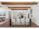 Elegant kitchen featuring a large marble island, wood beams, pendant lights, and modern design at 3801 Bayshore Blvd, Tampa, FL 33611