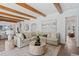 Bright living room showcasing a comfortable sectional sofa, wood beams, and stylish decor at 3801 Bayshore Blvd, Tampa, FL 33611
